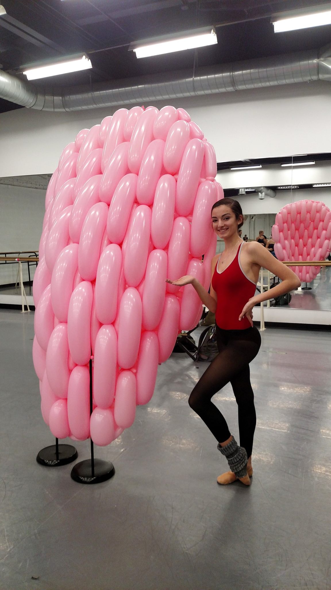 Rochester City Ballet Dancer stands next to a piece of the balloon set created by Airigami Studio