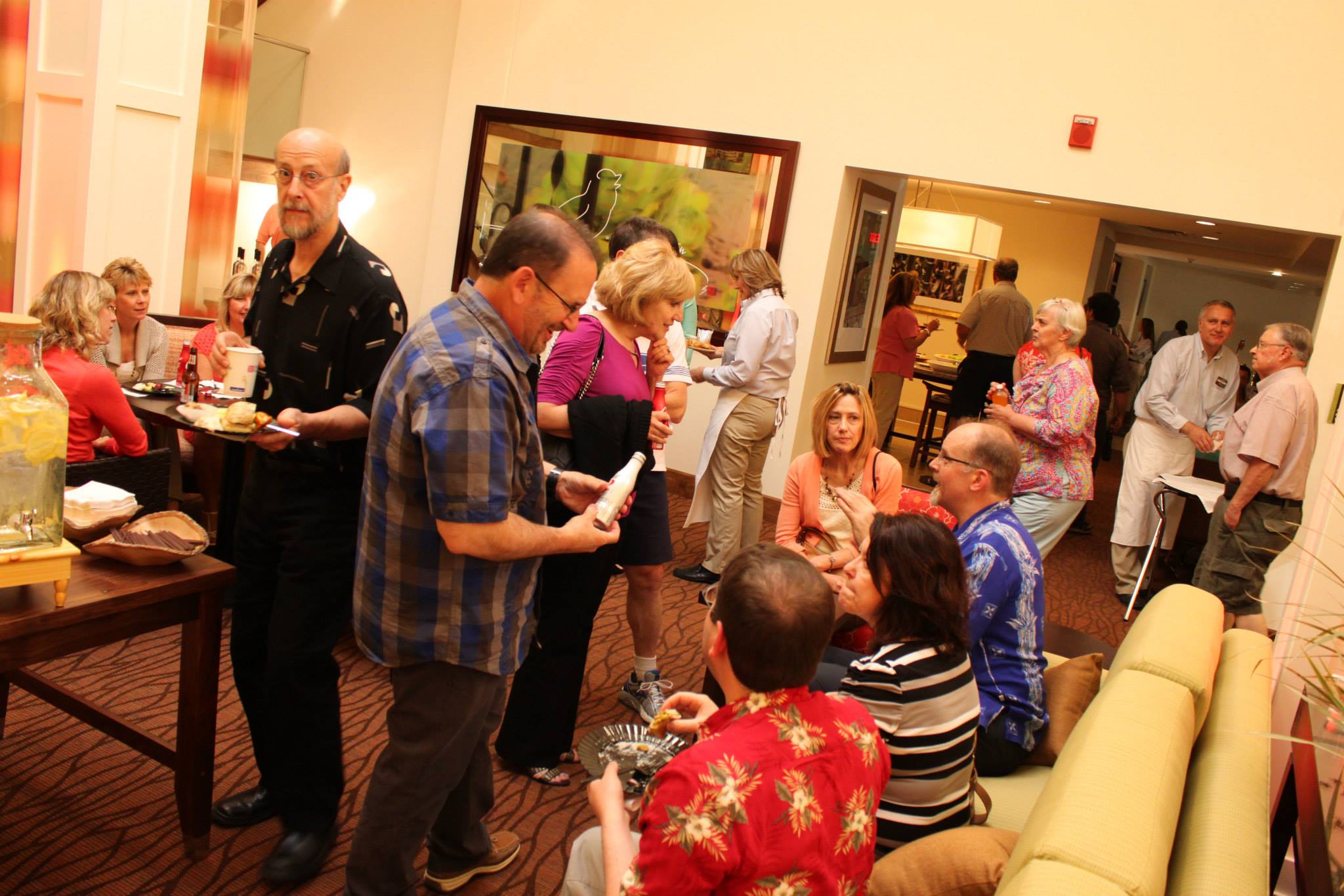 people celebrate in the lounge of the Hilton Garden Pittsford