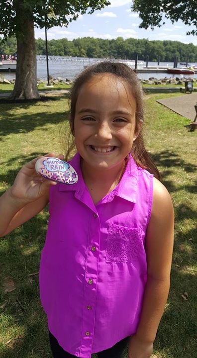 Child with purple painted rock in Bristol