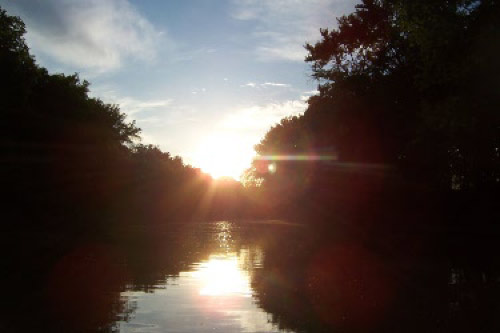 Sun reflecting on the Iroquois River in Northwest Indiana