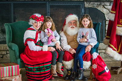 Photo by Nomadic Traveler Photography Two girls visit with Mrs. Claus and Santa