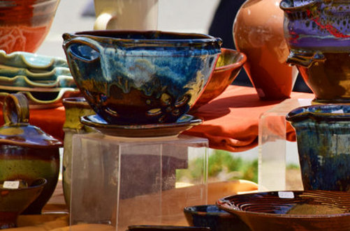 Art in the Park A table is spread with a variety of pottery