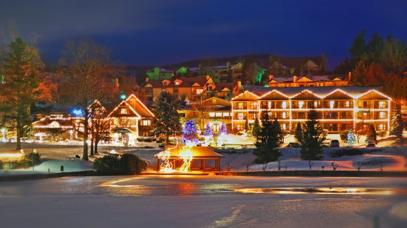 Christmas light forms surround the lake and manor at Chetola Resort