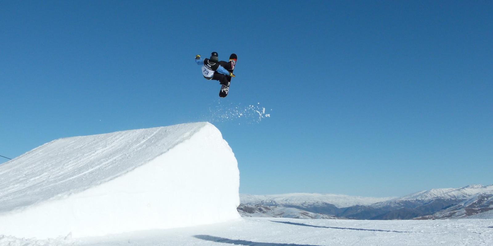 Snowboarder competing at the Winter Games Snowboarder competing at the Winter Games