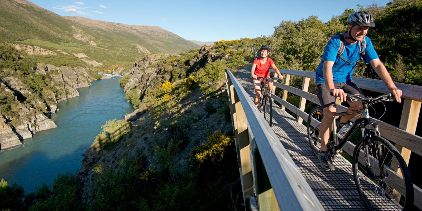 Couple Cycling Queenstown Trail Couple Cycling Queenstown Trail