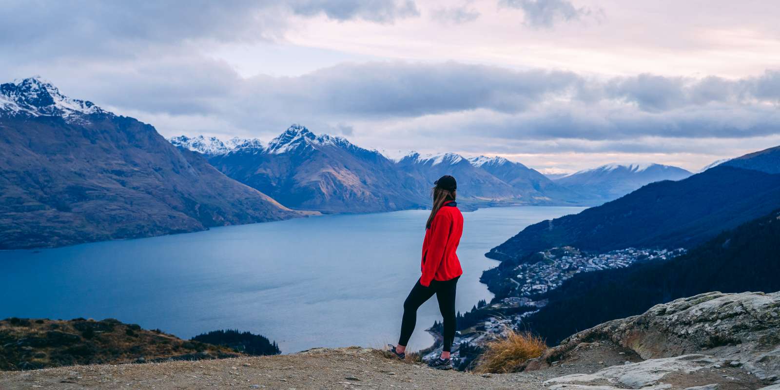 Queenstown Hill Spring Hike People at the top of Queenstown Hill overlooking town and view of Whakatipu lake and mountains
