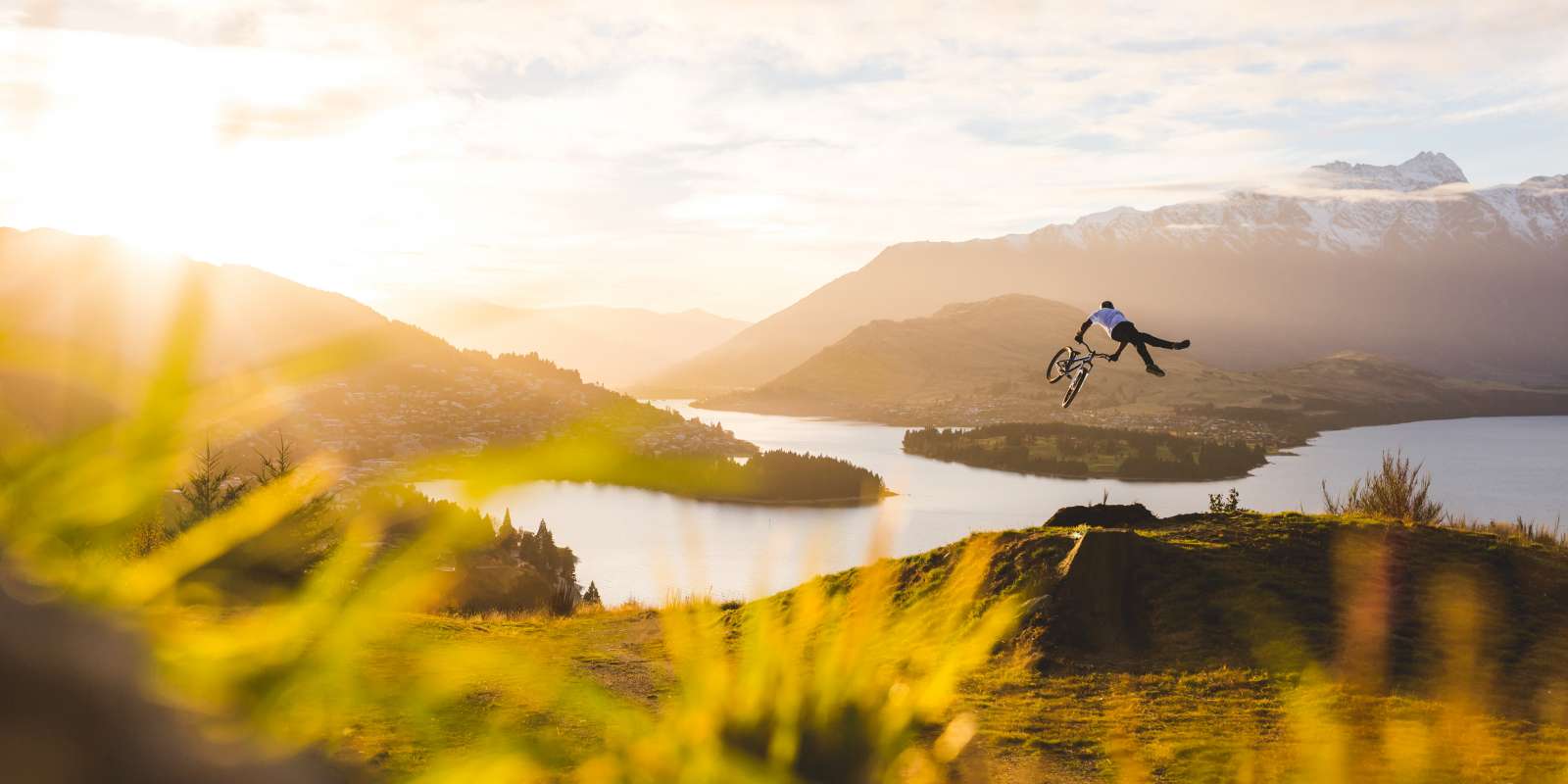 Mountain biker jumping above Queenstown, NZ Mountain Biker Jumping in Queenstown New-Zealand