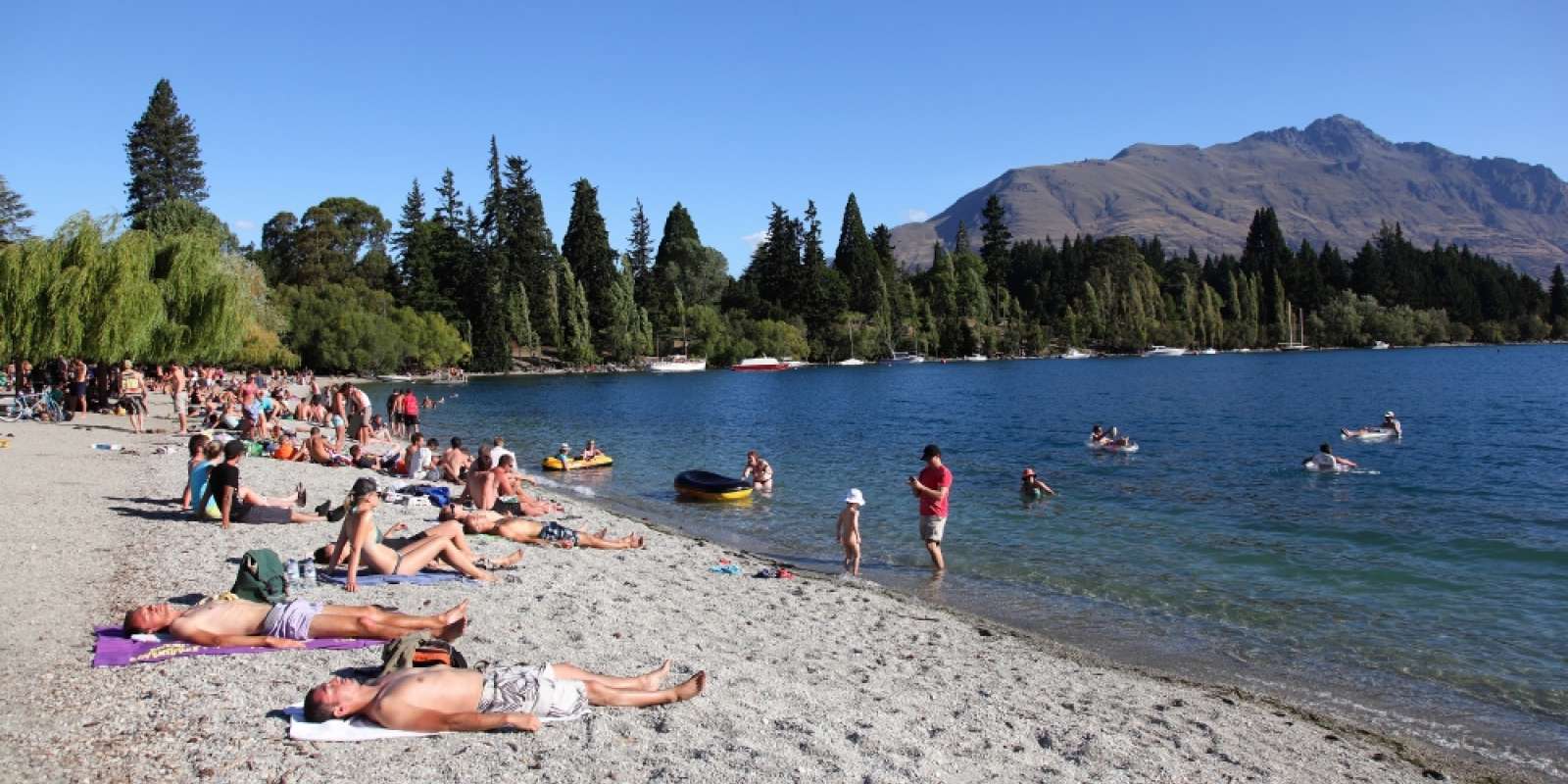 Queenstown Bay in Summer Sunbathers on the shores of Queenstown Bay in Summer