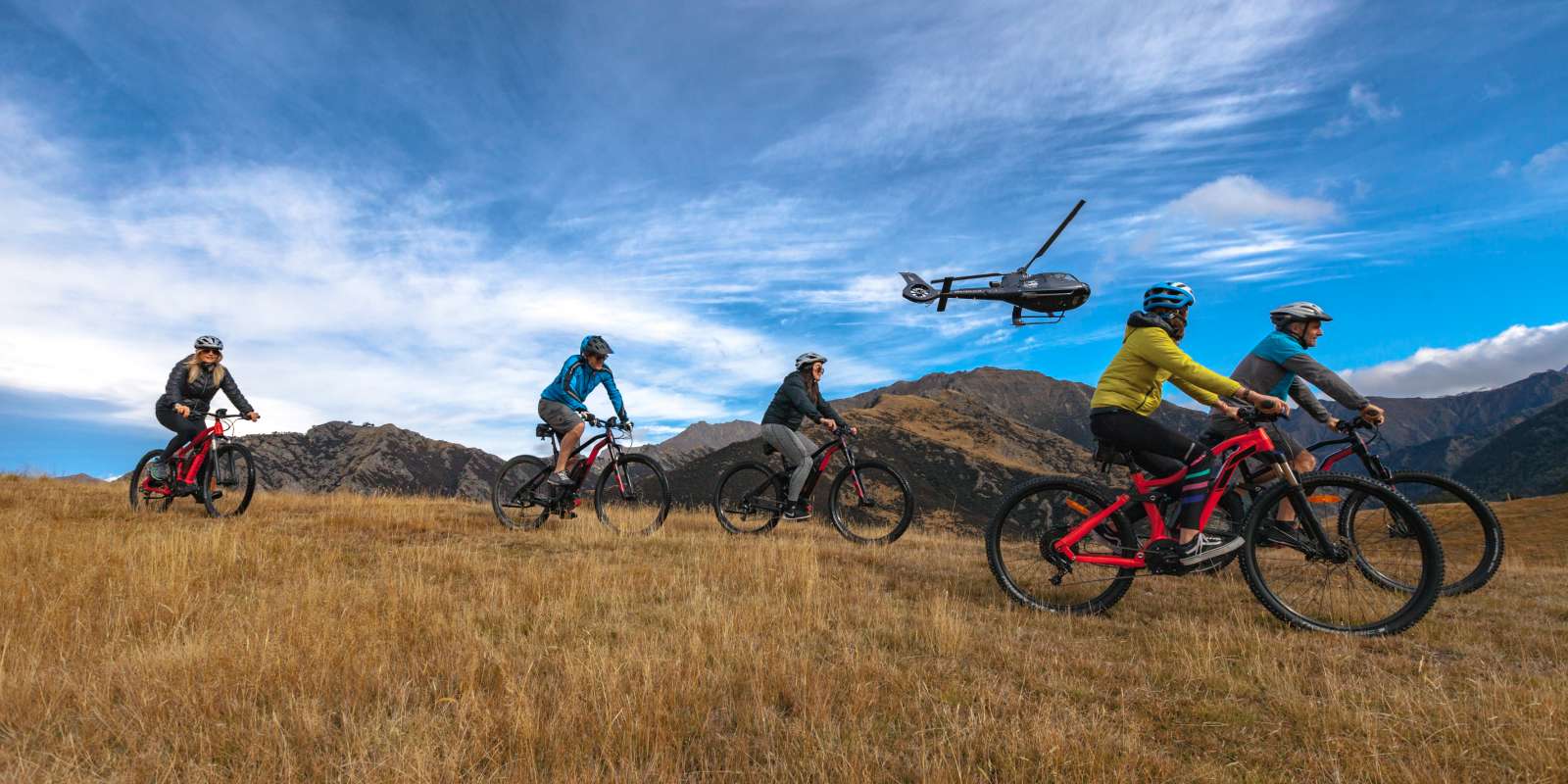 Over The Top Heli eBiking in Queenstown takeoff join a heli-ebiking adventure combining the thrill of a helicopter ride with riding in a high country farm