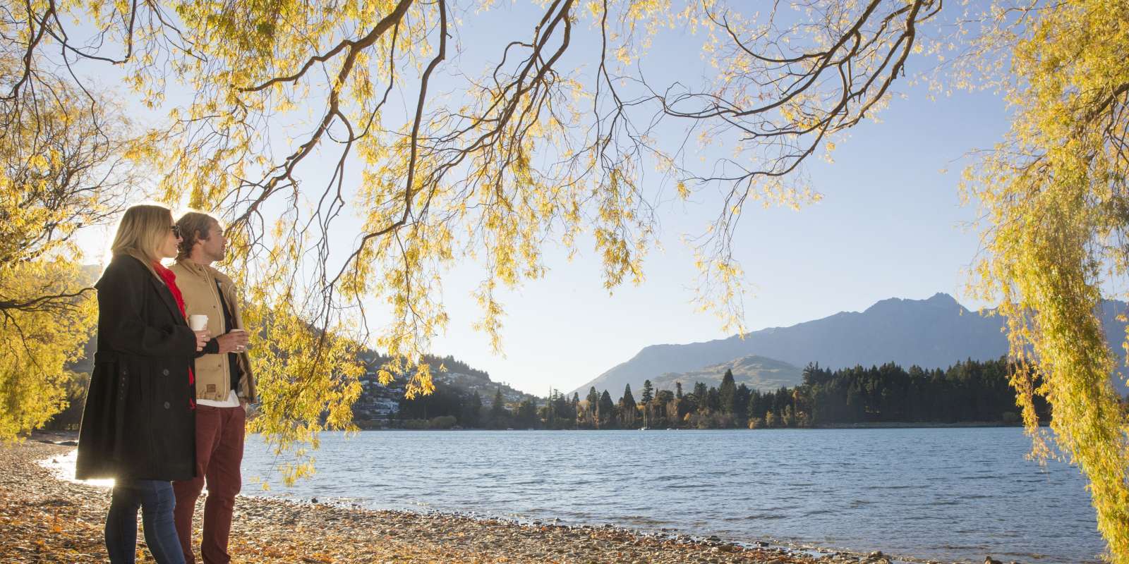 Lake Wakatipu in Autumn Couple having coffee beside Lake Wakatipu in Autumn