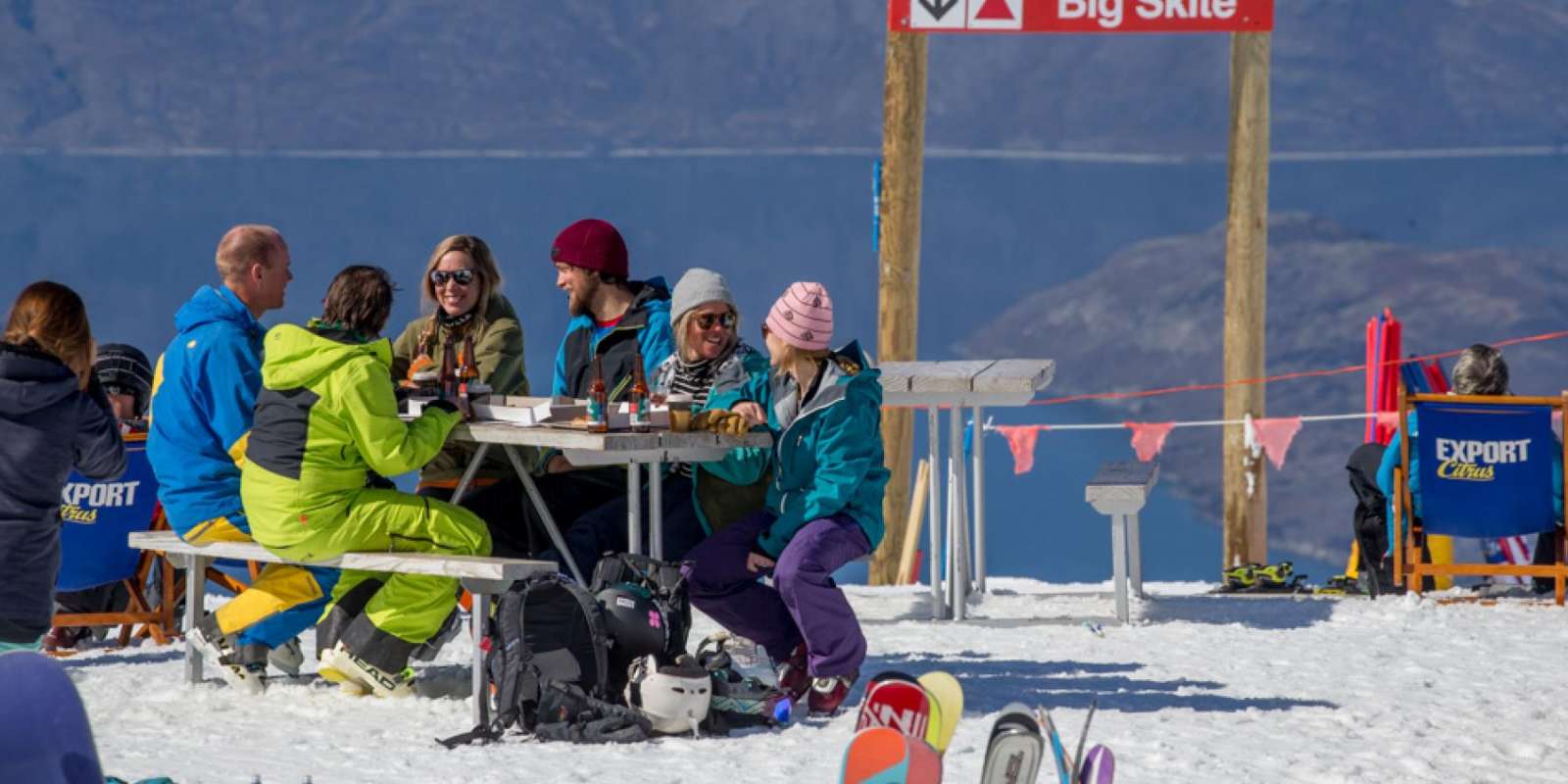 Having a ski break at Treble Cone Ski Area Friends having drinks and food at Treble Cone Ski Area
