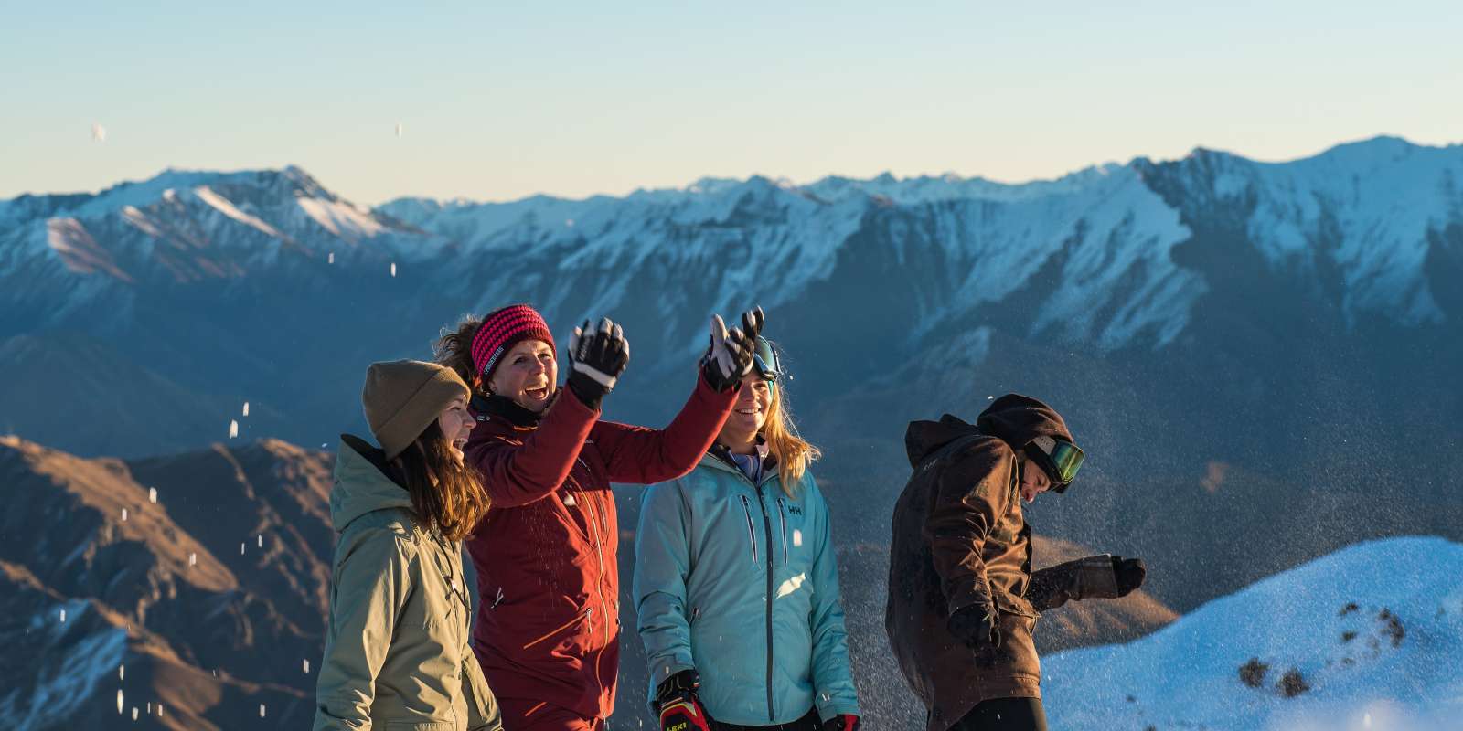 Friends at Coronet Peak Ski Field Jet Sprints at Oxbow Adventure Co. under snowwy mountains