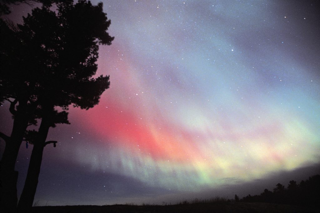 The aurora borealis or northern lights fill the sky near Harlow Lake near Marquette Michigan in the Upper Peninsula.