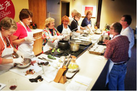 The Santa Fe School of Cooking guides students through the art of preparing green chiles. Green Chile Turkey Enchiladas, anyone?
