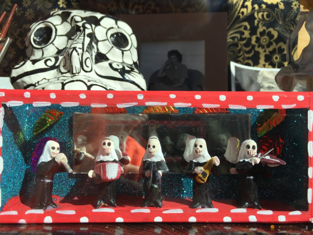 The Mira! window display displays some of its Dia de los Muertos folk art.