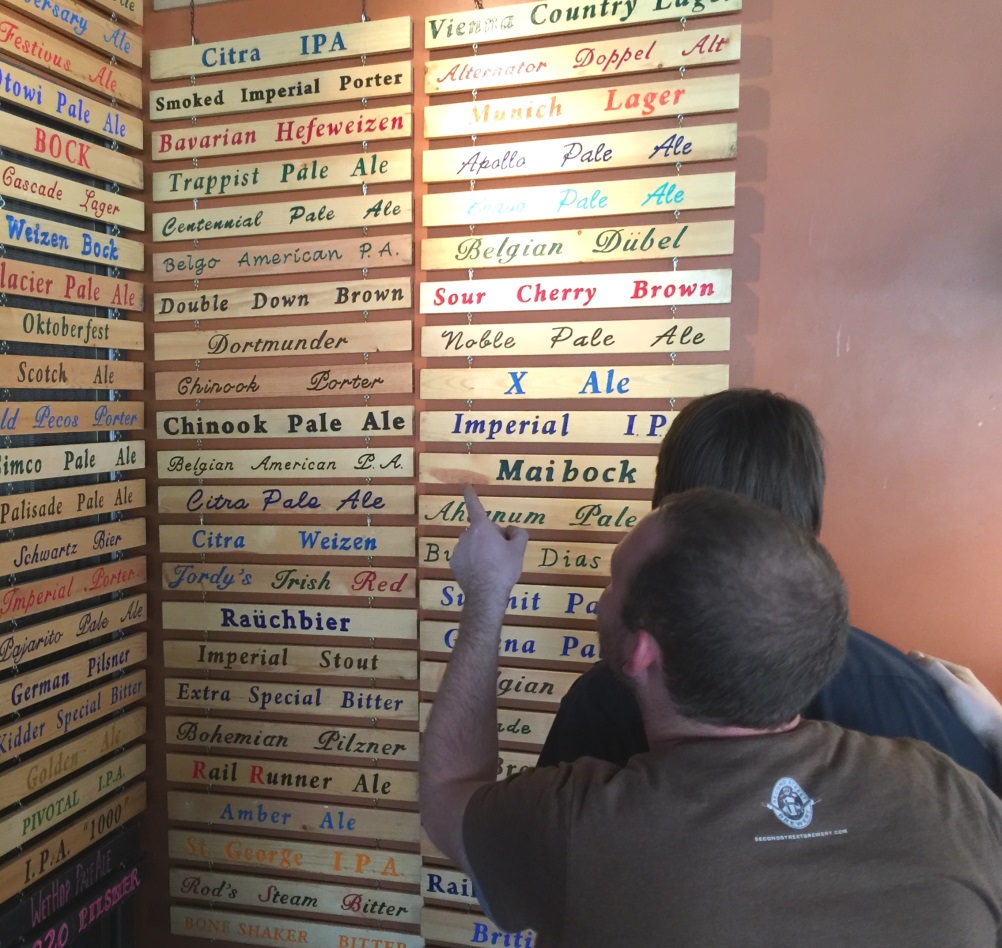 Second Street Brewery employees look over the extensive list of microbrews.