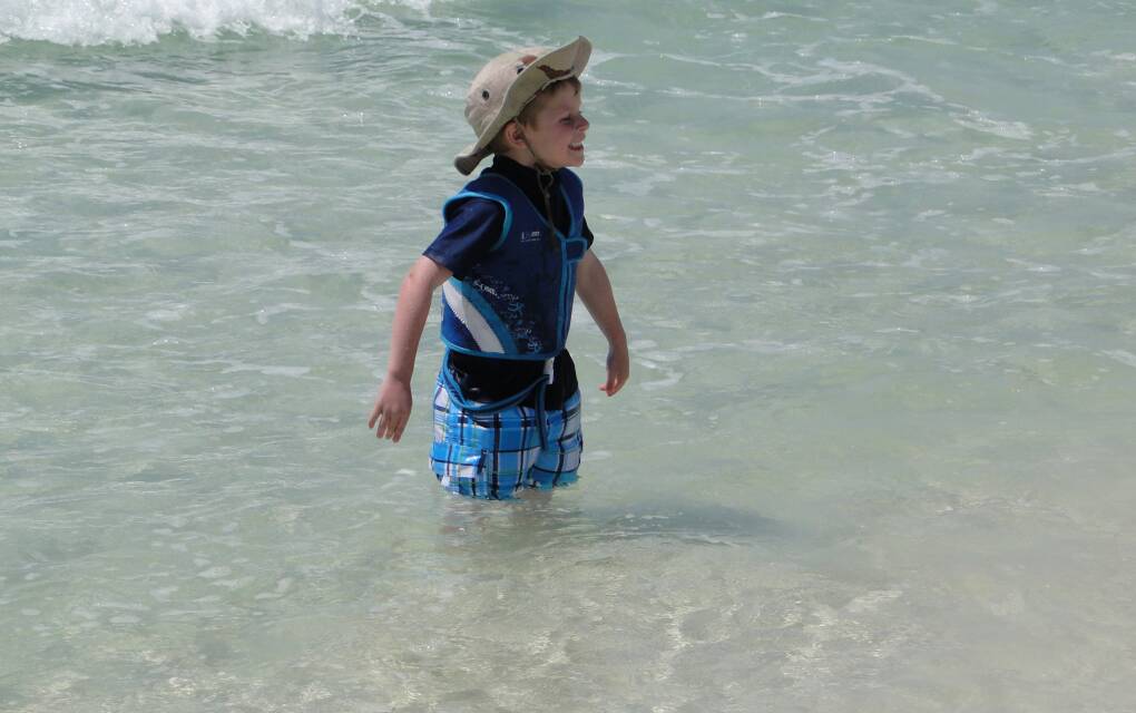 A little boy plays in the water at Henderson Beach Park in Destin.