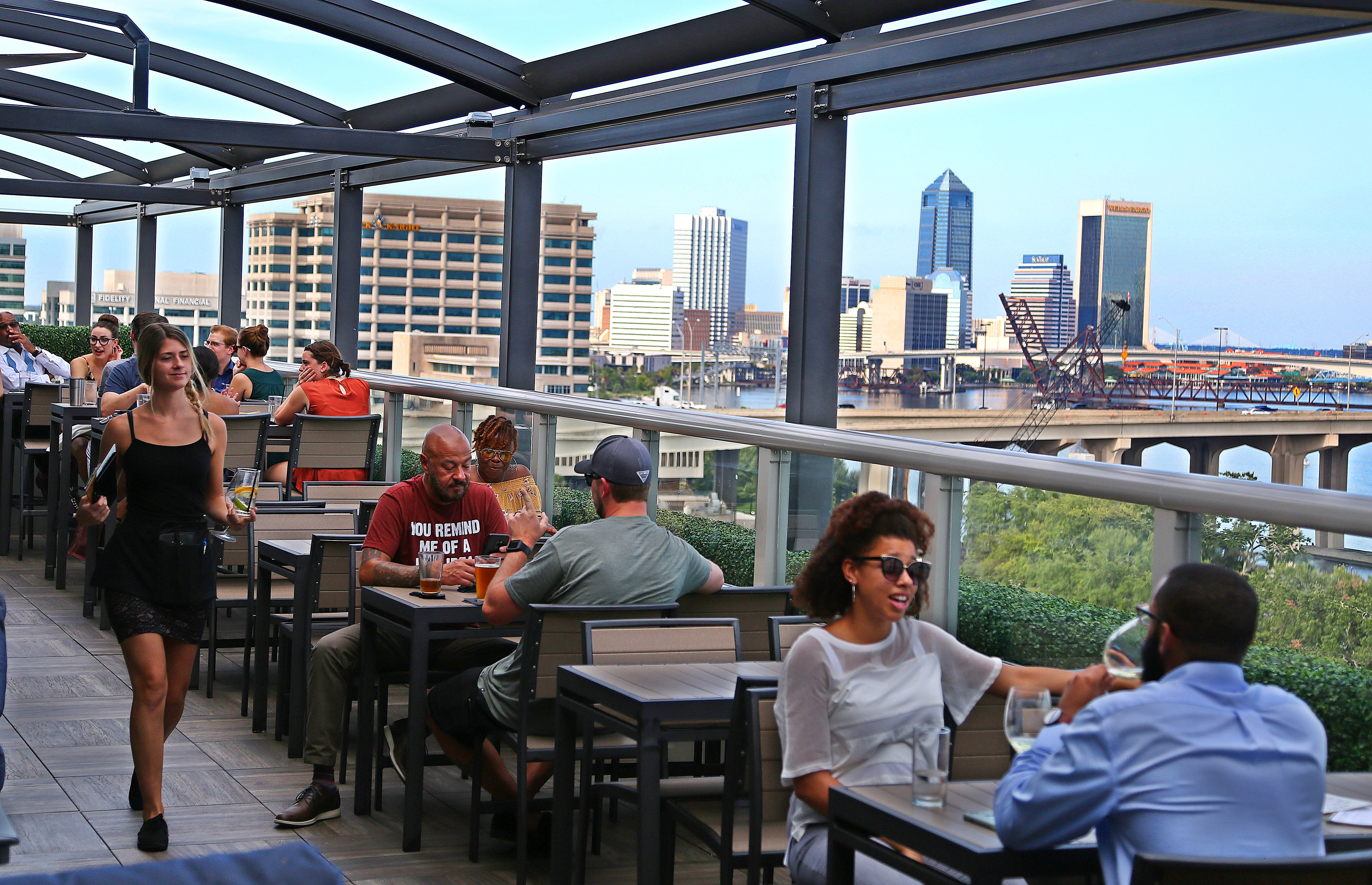 Jacksonville's River & Post Restaurant offers various cocktails with a view of downtown Jacksonville from a rooftop bar. 