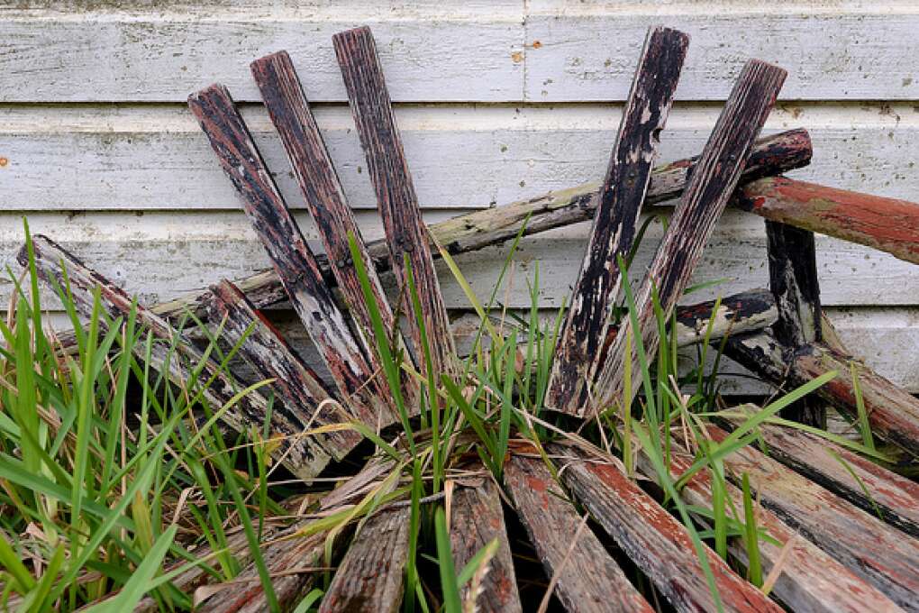 A broken bench rests against the Lawrence Store, now closed, in Two Egg