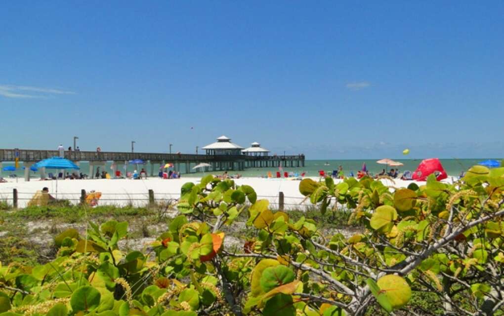 The Fort Myers Beach Pier stretches into the Gulf in the distance.