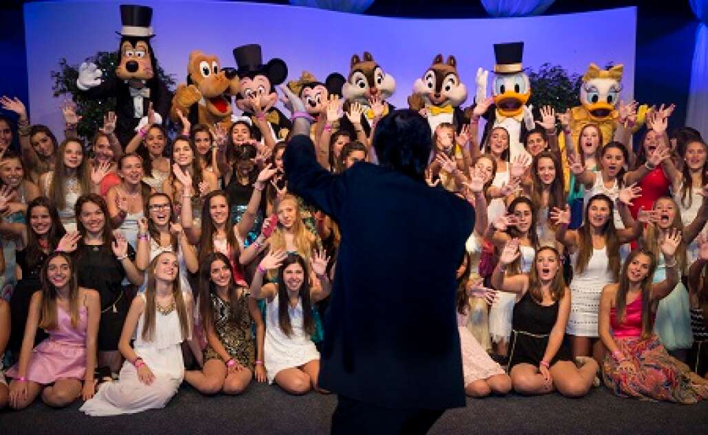 group of girls taking pictures with Disney characters at their quinceanera party