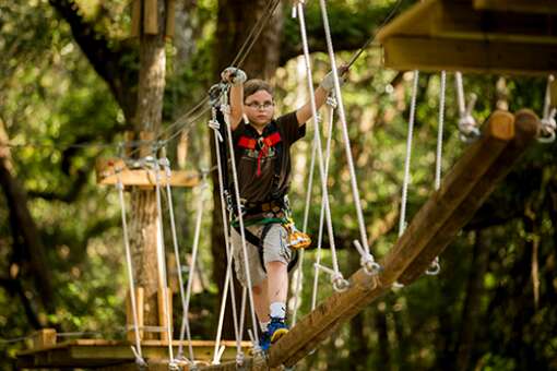 TreeHoppers Aerial Adventure Park presents a variety of physical challenges from walking between trees on a system of ropes and boards and pulleys to ziplining between platforms.