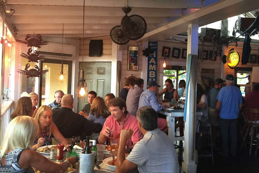 Diners enjoy dinner at Owen's Fish Camp in Sarasota. The business serves mostly local seafood updating Southern classics.  