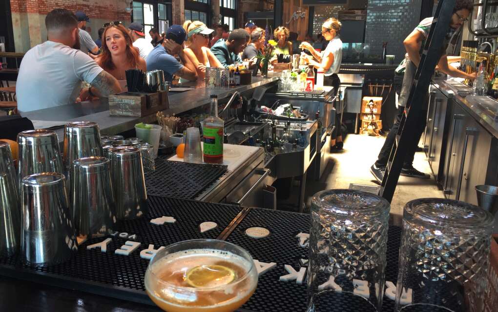 The bar at Fine & Dandy Cocktail Emporium can be four people deep on weekends at the Heights Public Market at Armature Works, Tampa. Grab a seat if you can and people watch while a sipping a cocktail.