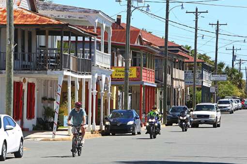 Bicycles, motorcycles and golf carts are some of the alternative ways to ride around historic parts of Cedar Key, like here along the historic Second Street looking east.  