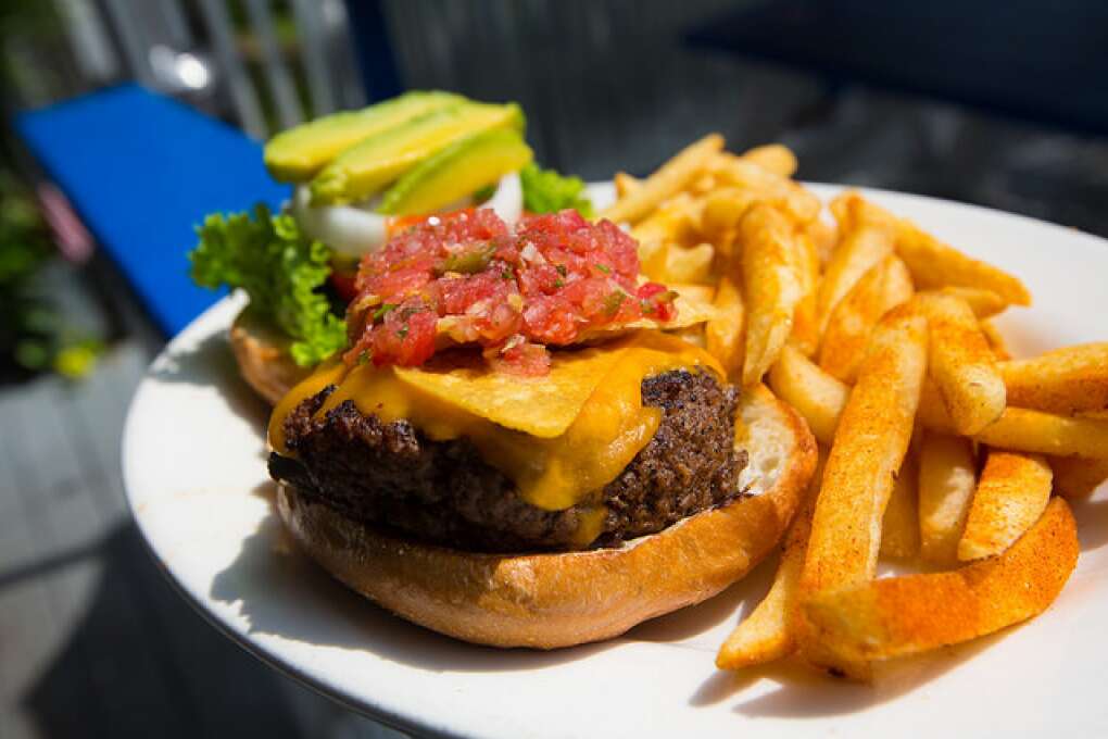 The Big Taco Burger at Lost Lagoon Wings & Grill in New Smyrna Beach is topped with taco seasoning, shredded cheddar cheese, salsa, avocado and tortilla chips and is served in a Kaiser bun.