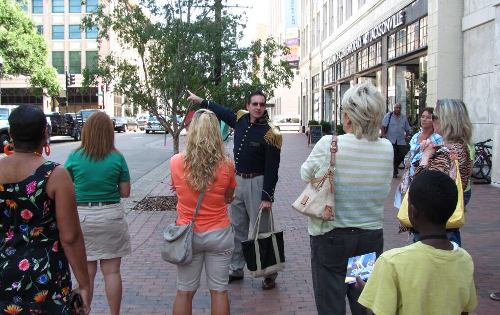 An Ad Lib Tour guide takes visitors past the historic downtown Jacksonville library on a walking tour of Jacksonville. Walking tours are a low-impact way for an eco-tourist to get to know a city. 