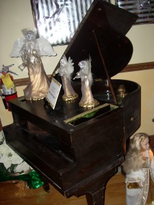 Check out the phonograph player in back of this fake piano!