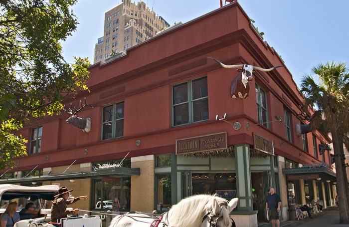 Red building with cattle head sticking out.