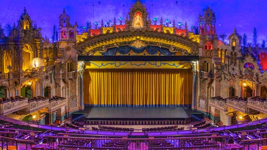 Majestic Theatre stage with gold curtain down.