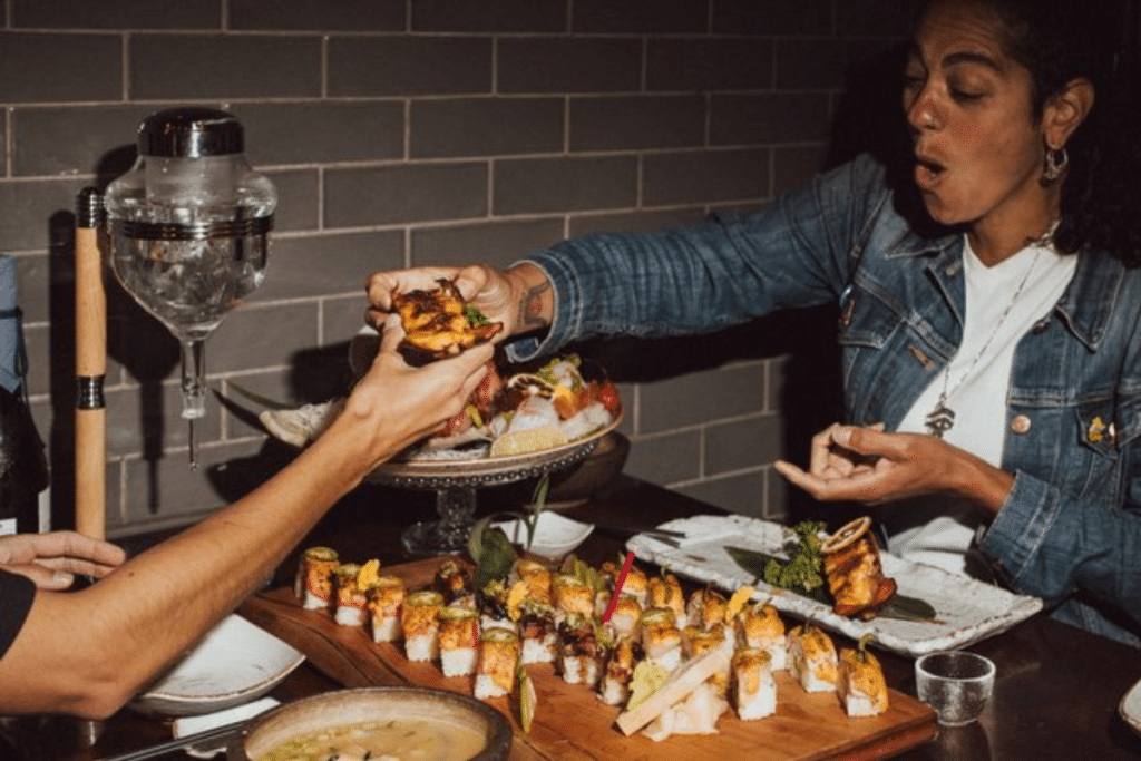 A woman enjoys sushi at Horang 