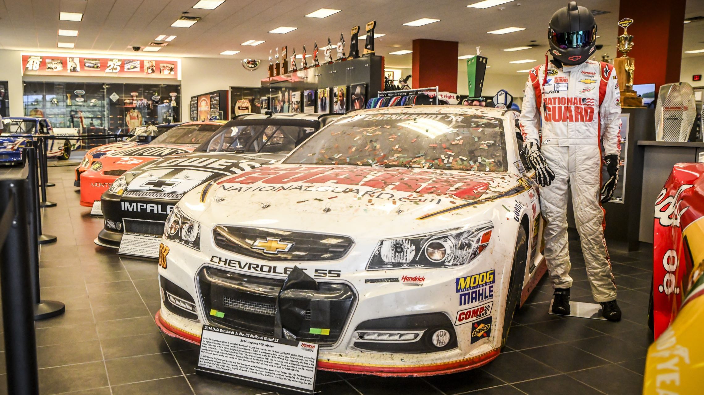 race car and fire suit on display inside museum
