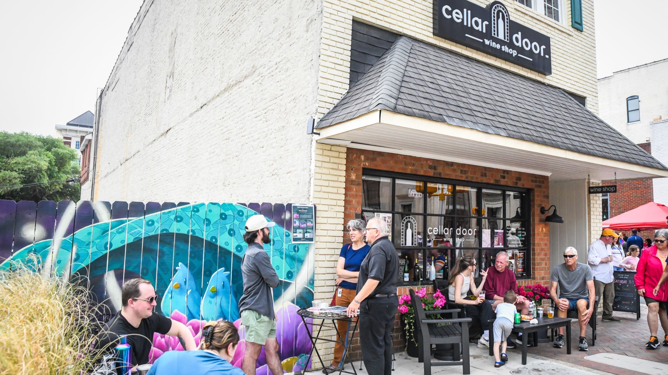 patrons gather outside local wine shop in historic downtown