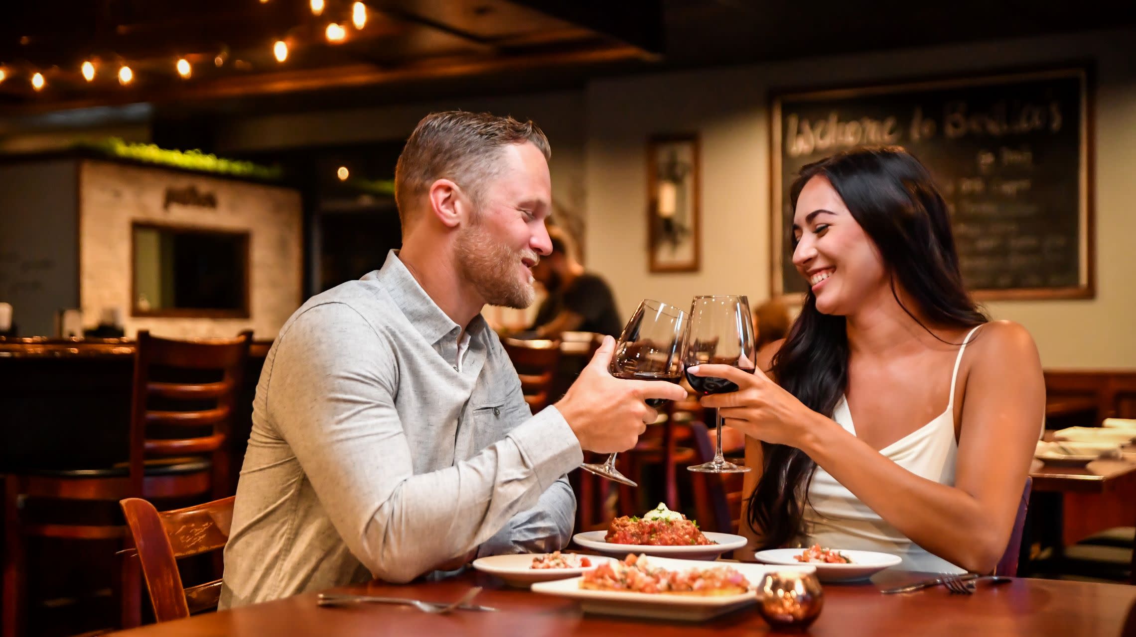 couple toasting wine glasses