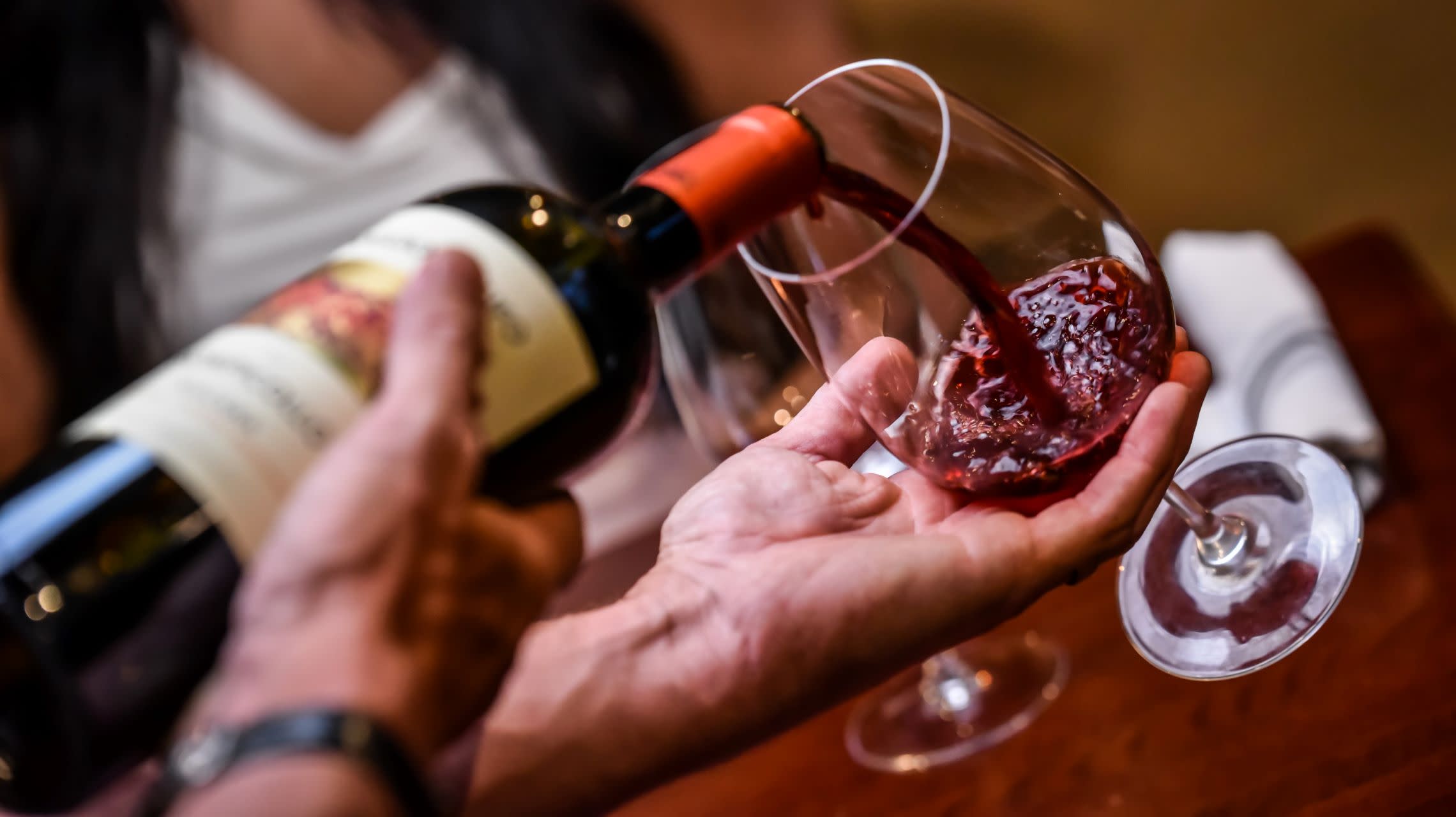 server pouring wine