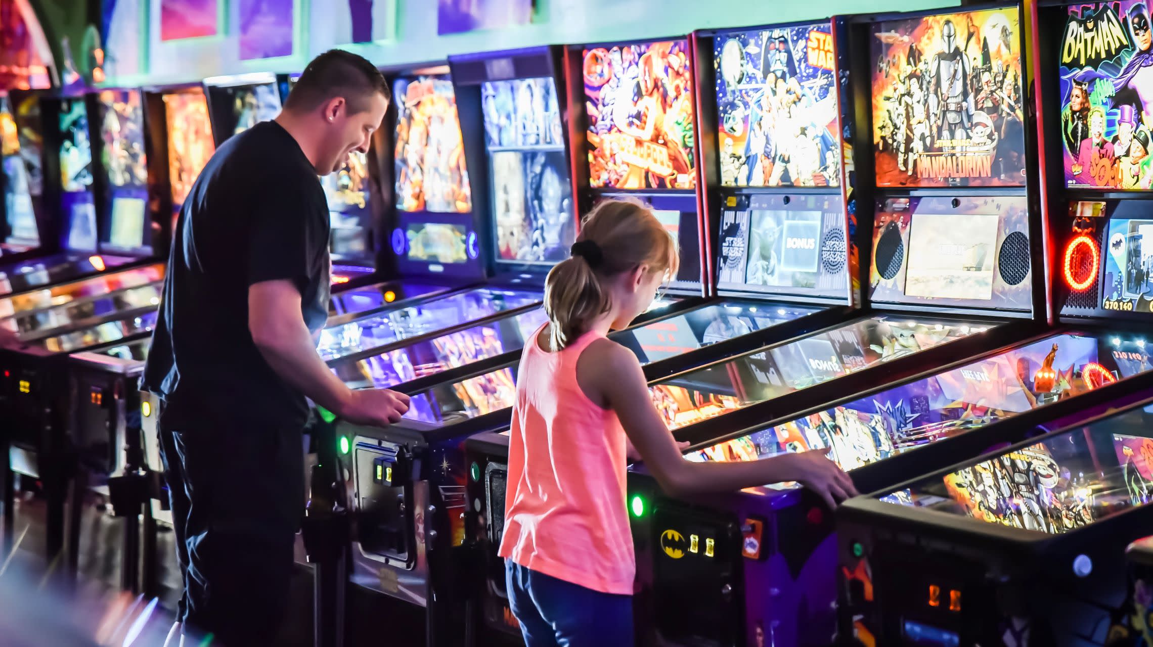 people playing pinball