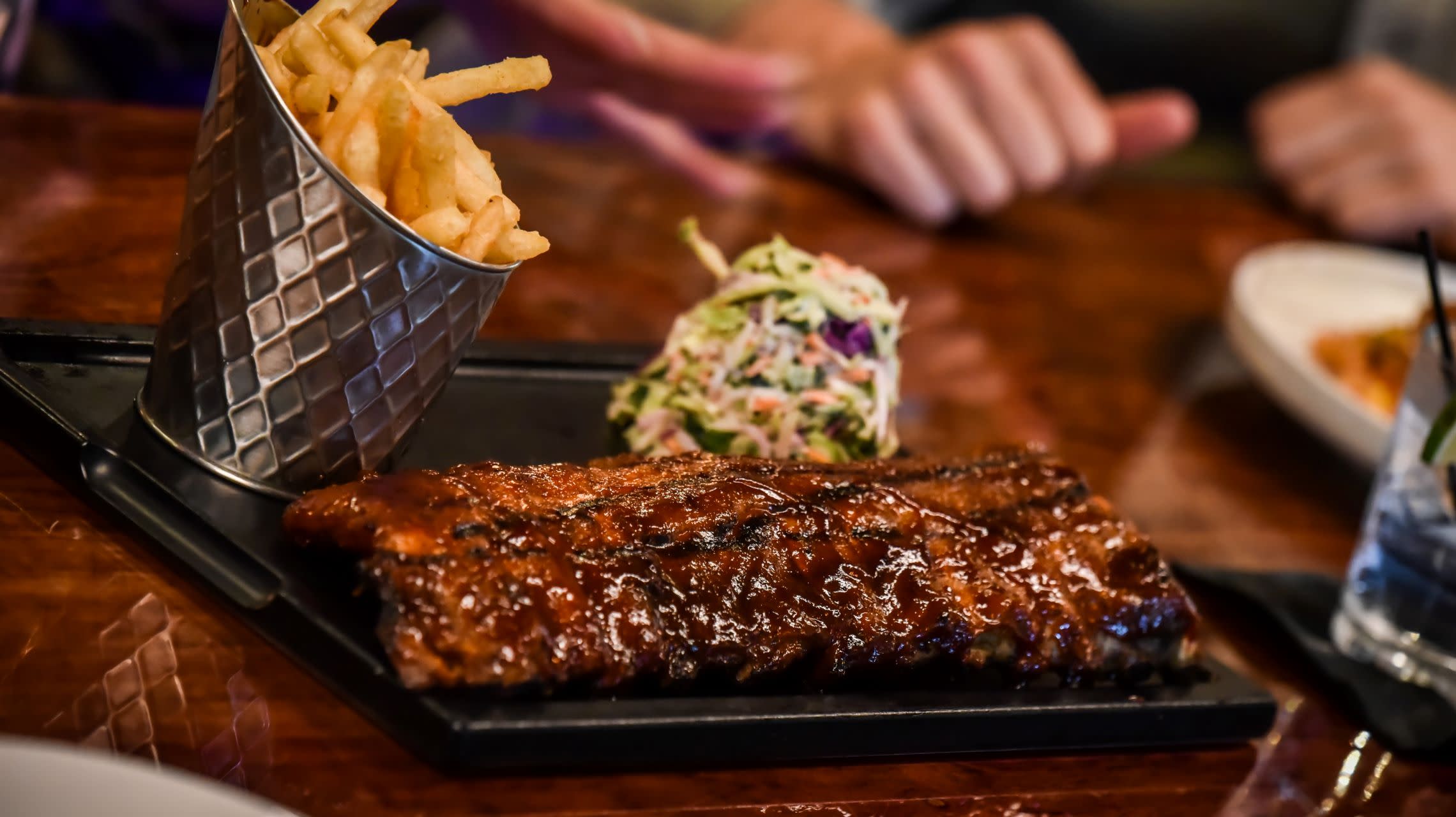 plate of barbecue ribs, fries and cole slaw