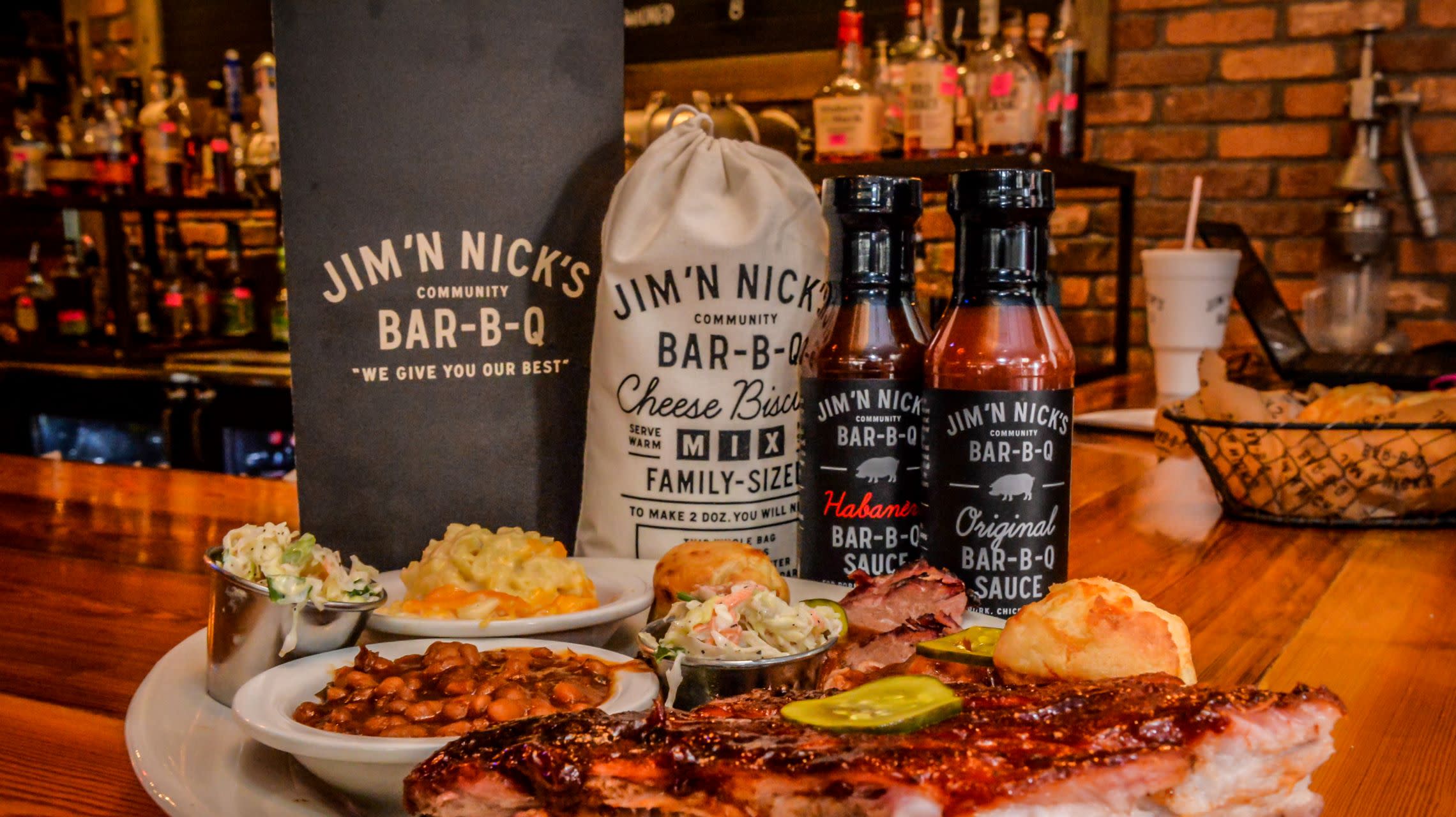 plate of barbecue and sides with sauce bottles