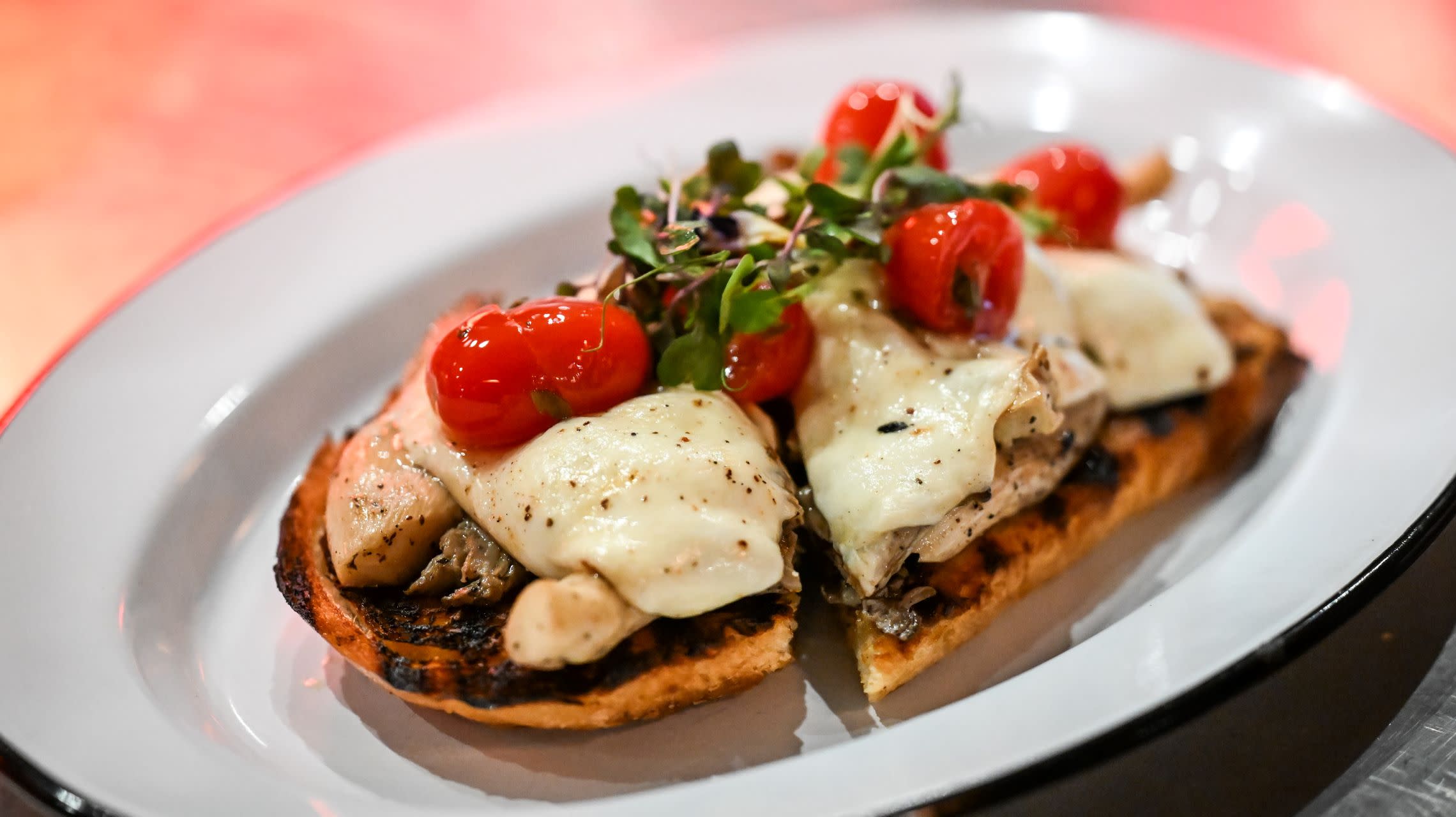sandwich topped with cheese and tomatoes