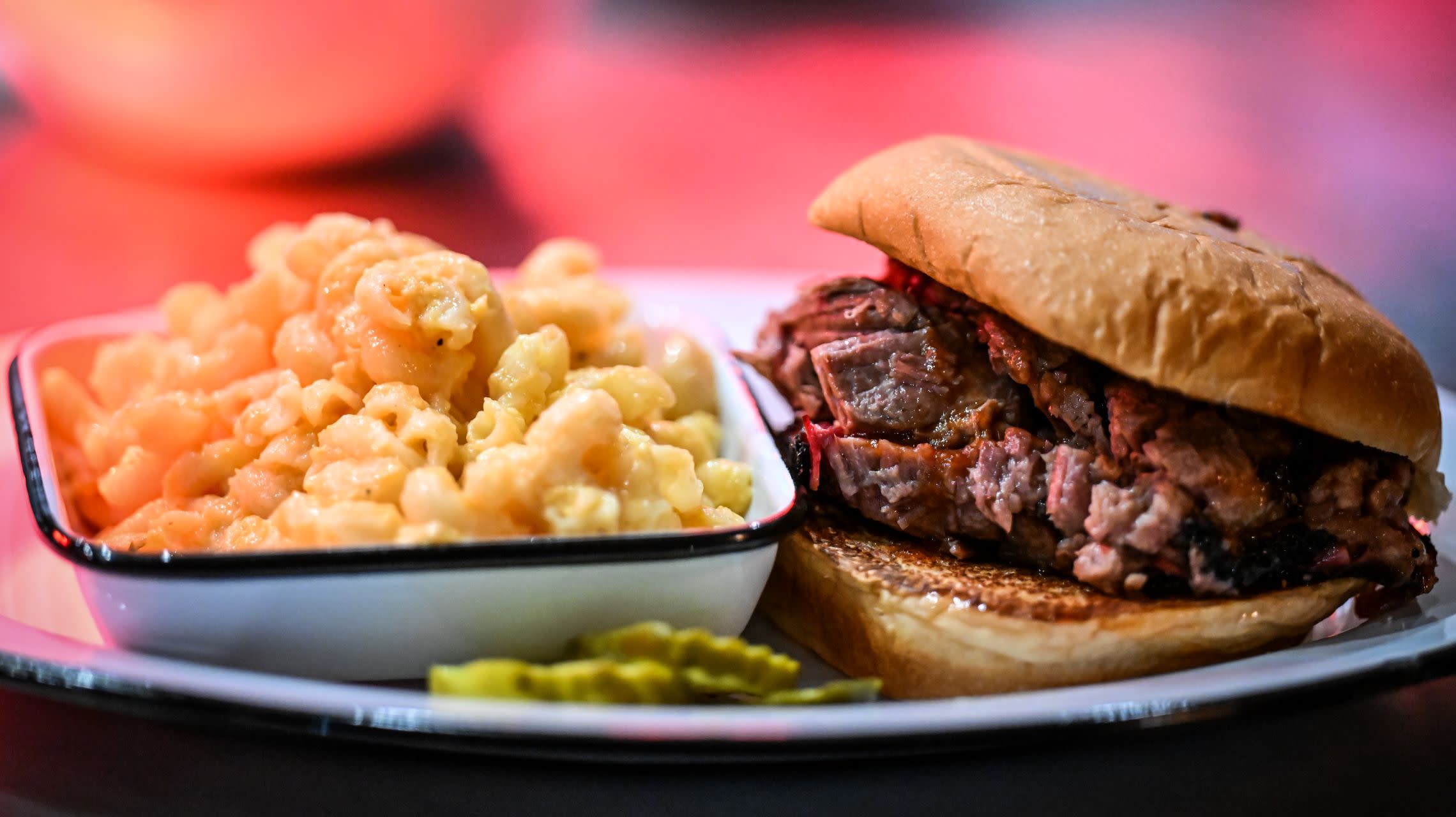 plate with barbecue sandwich and side of macaroni and cheese
