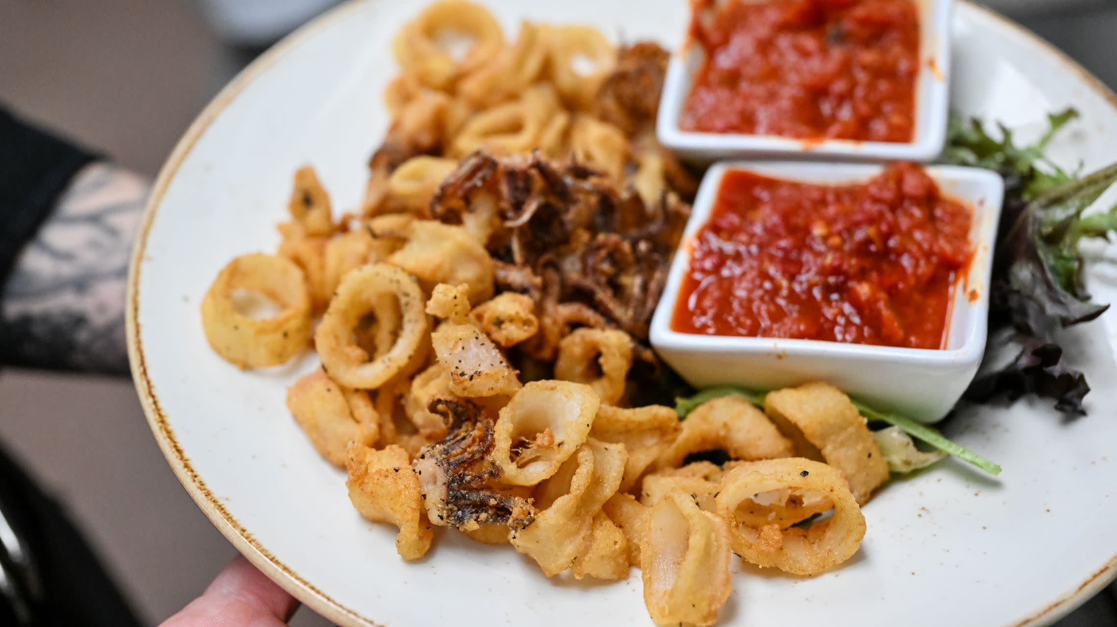 plate of fried calamari with marinara sauce
