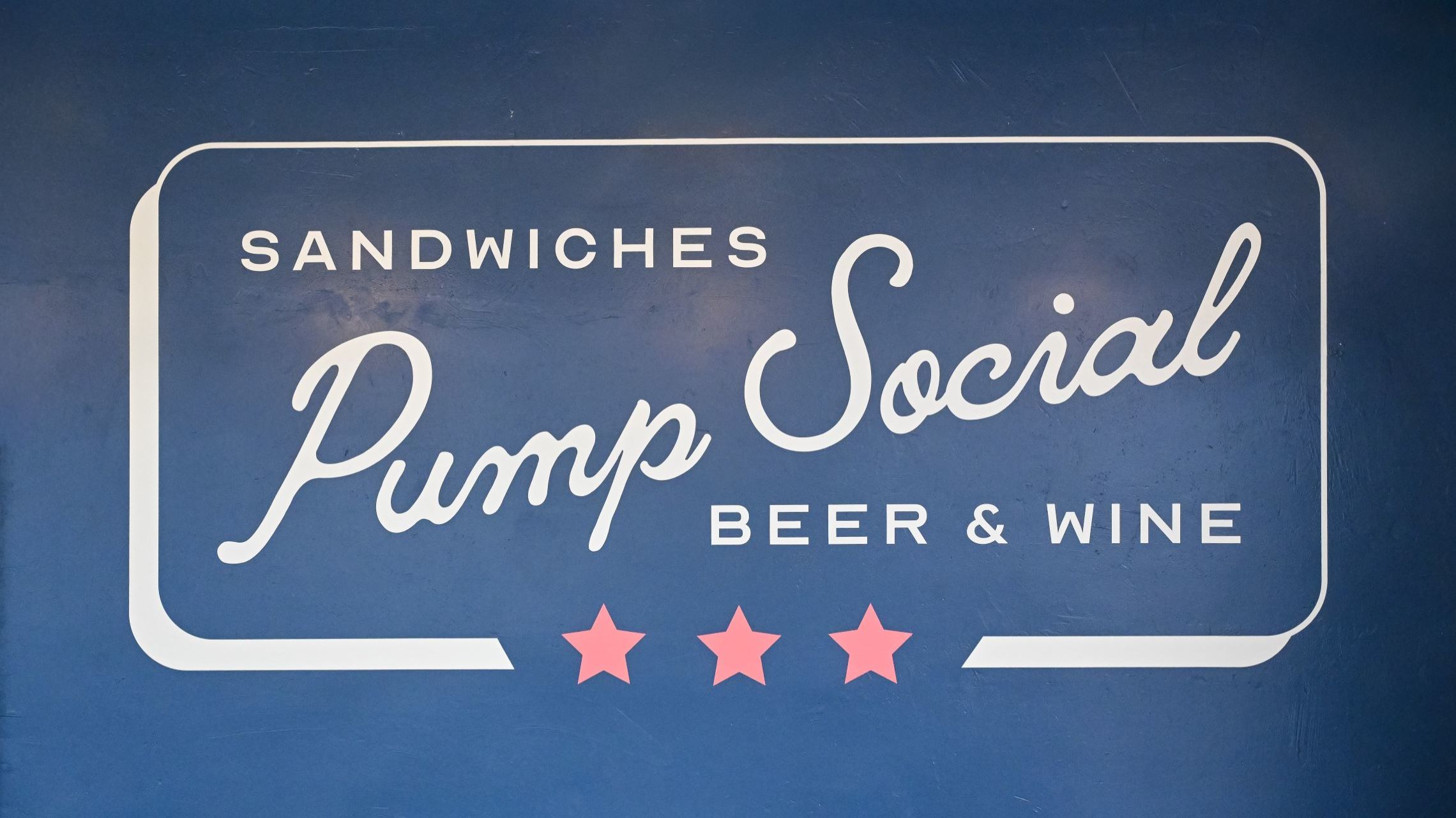 Pump Social logo painted on restaurant wall