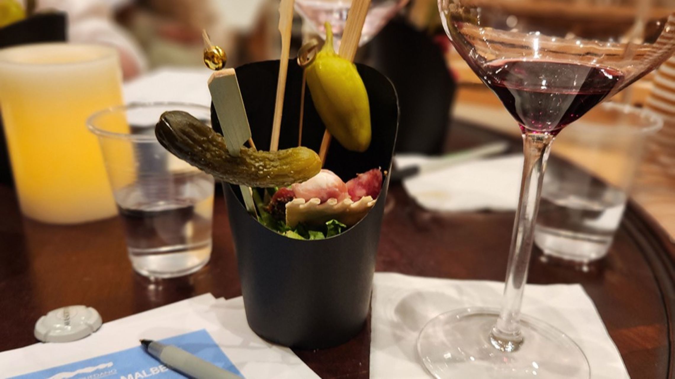 charcuterie snack and glass of wine on table