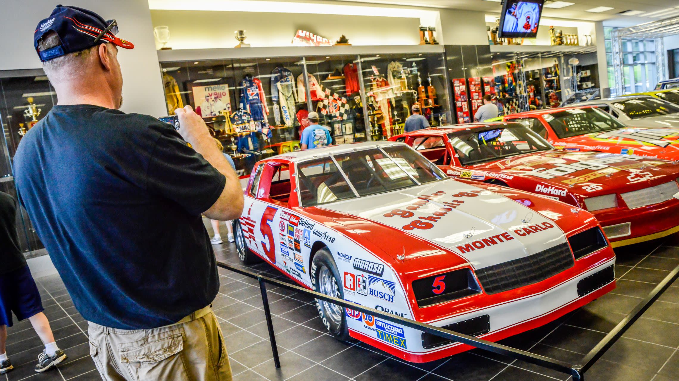 fan takes photo of race car on display