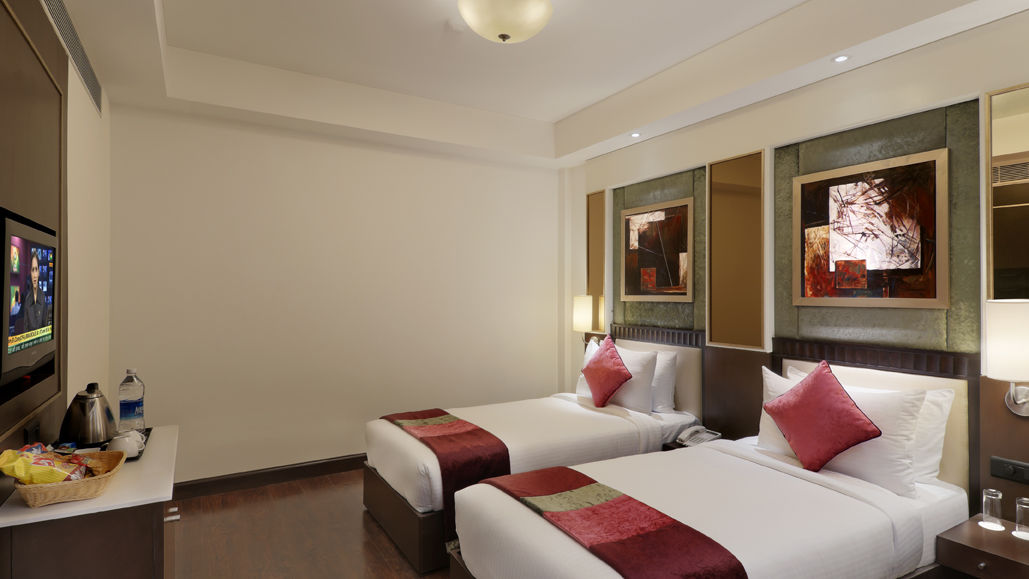 view of twin bed in Premium twin room of Inde Hotel Vista Woods, Gurgaon 