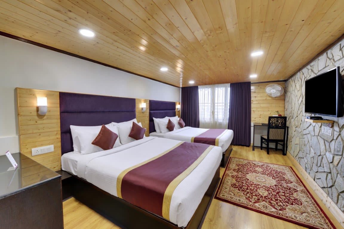 An image of a room with twin bed, flat screen TV, decorative lighting - Sumitel Darjeeling